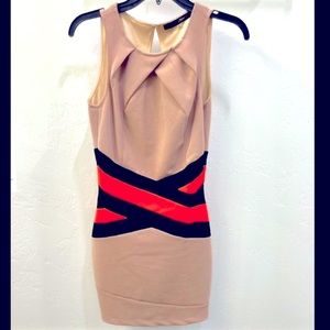 Tan bandage dress with bright orange and black waist detailing.